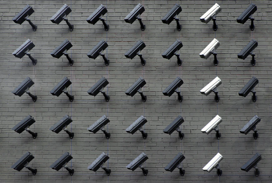 Bank of security camera monitors representing AI-powered video analytics for businesses