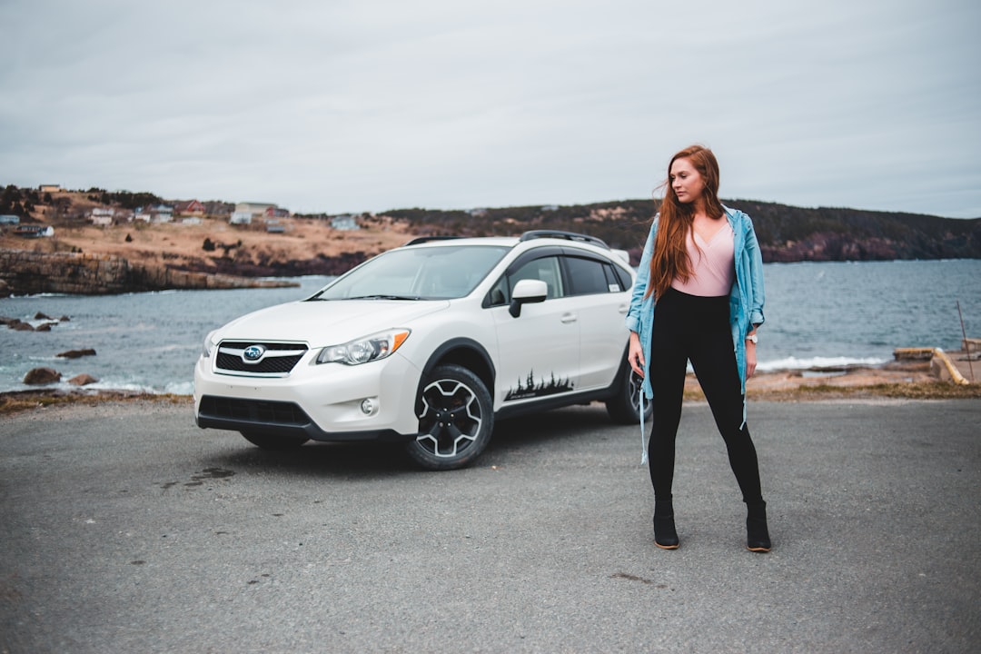 woman standing near white SUV
