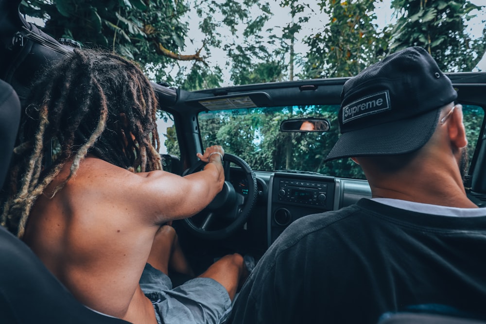 two men riding in vehicle