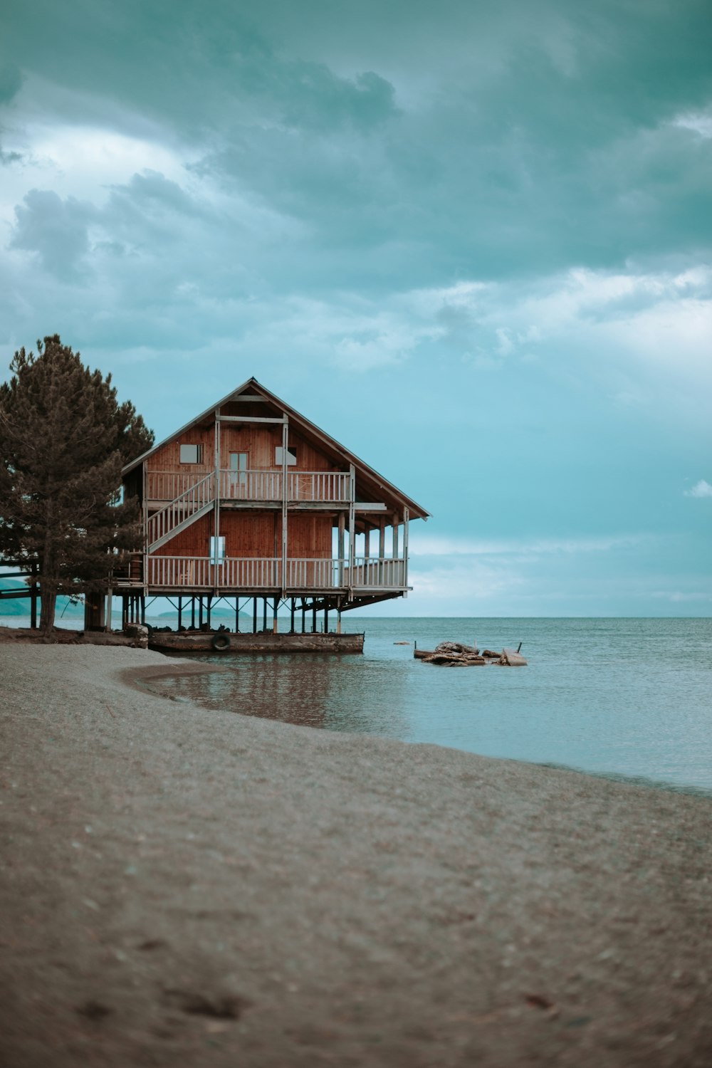 brown wooden 2-story house near body of water