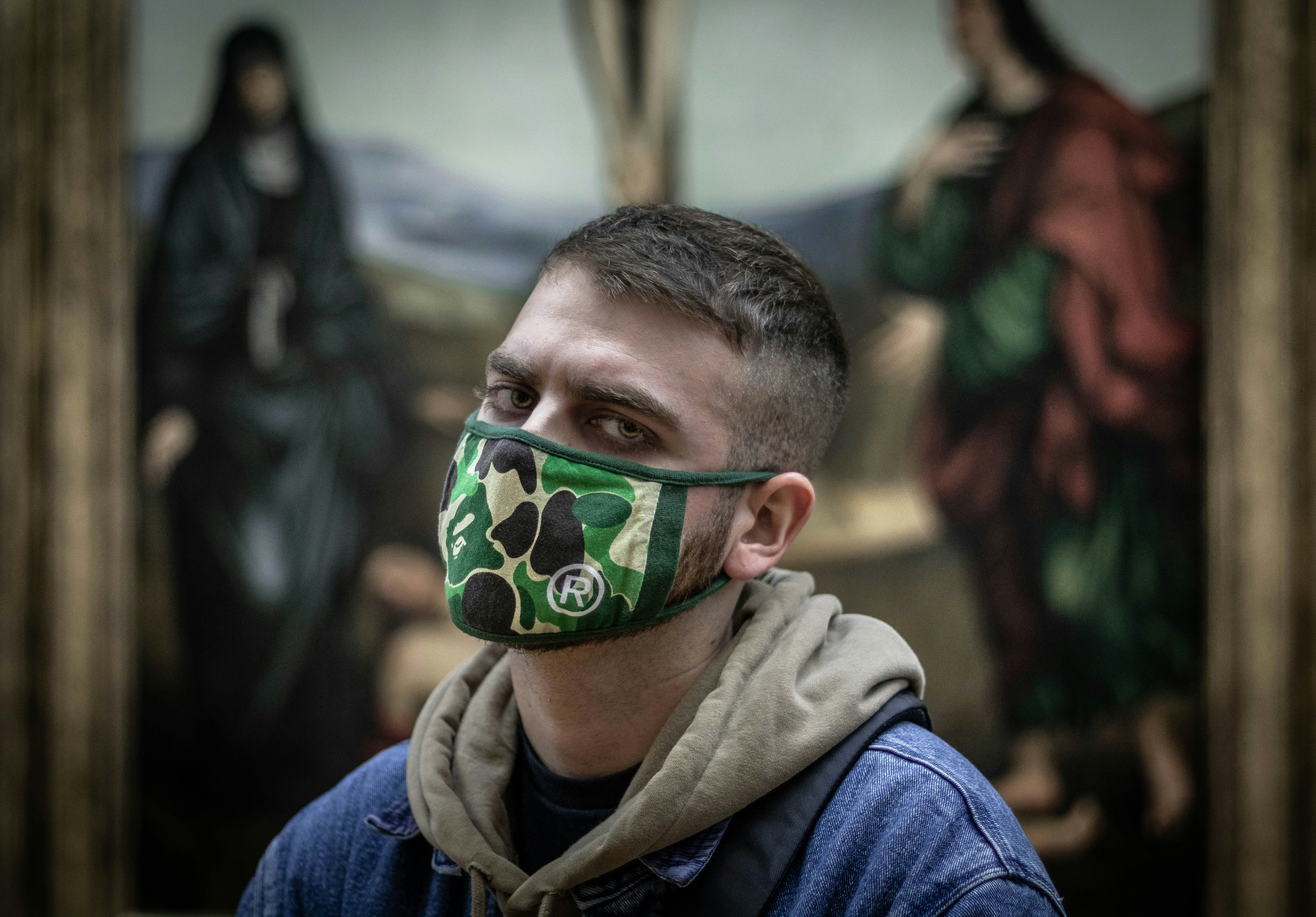 man wearing green camouflage mask