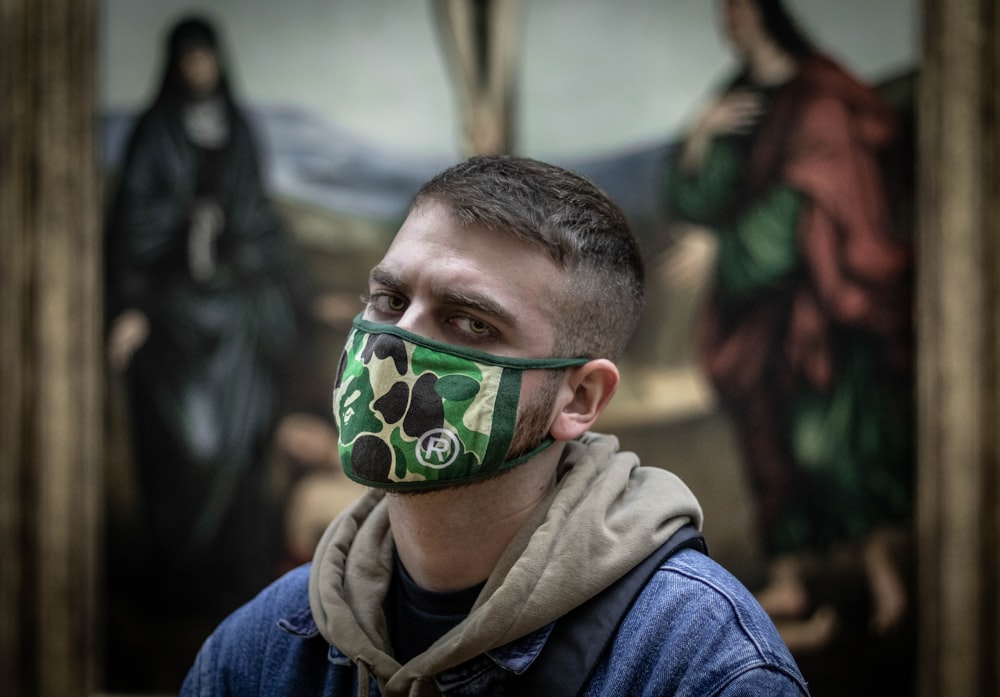 man wearing green camouflage mask