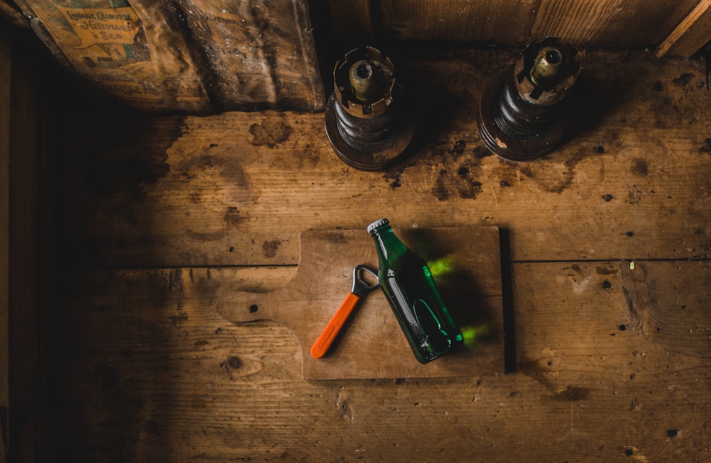 bottle opener beside bottle on cutting board