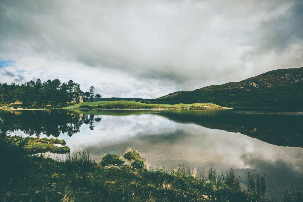 body of water under white sky