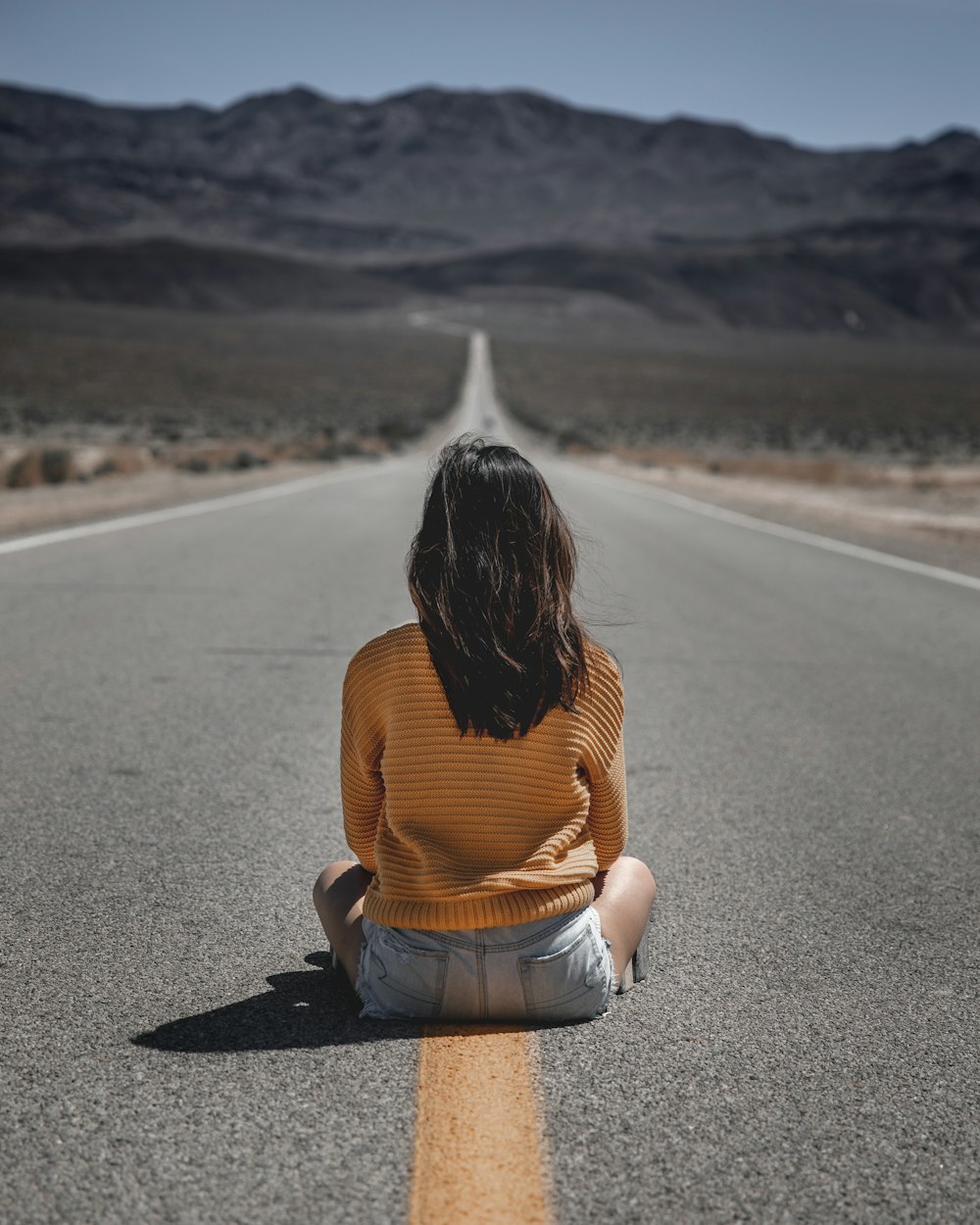 woman sitting on the road