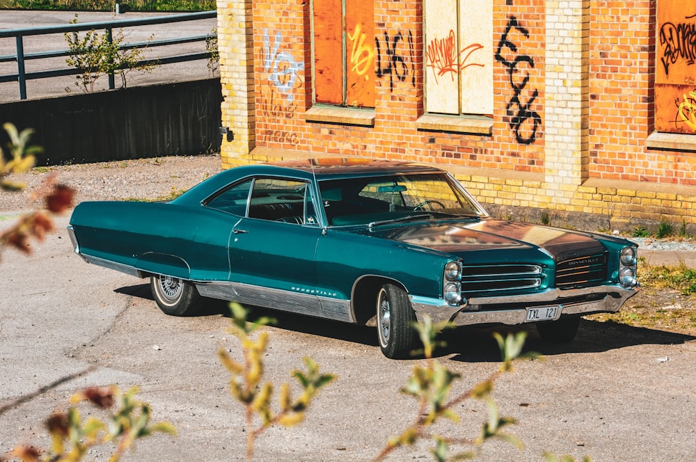 classic green coupe parked near building during daytime