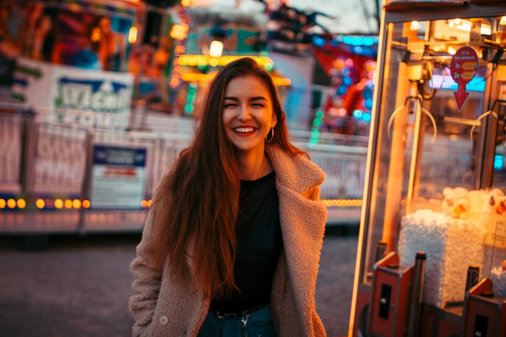 smiling woman wearing brown coat