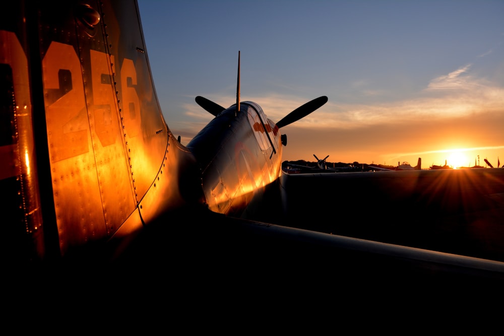 black and red plane during golden hour