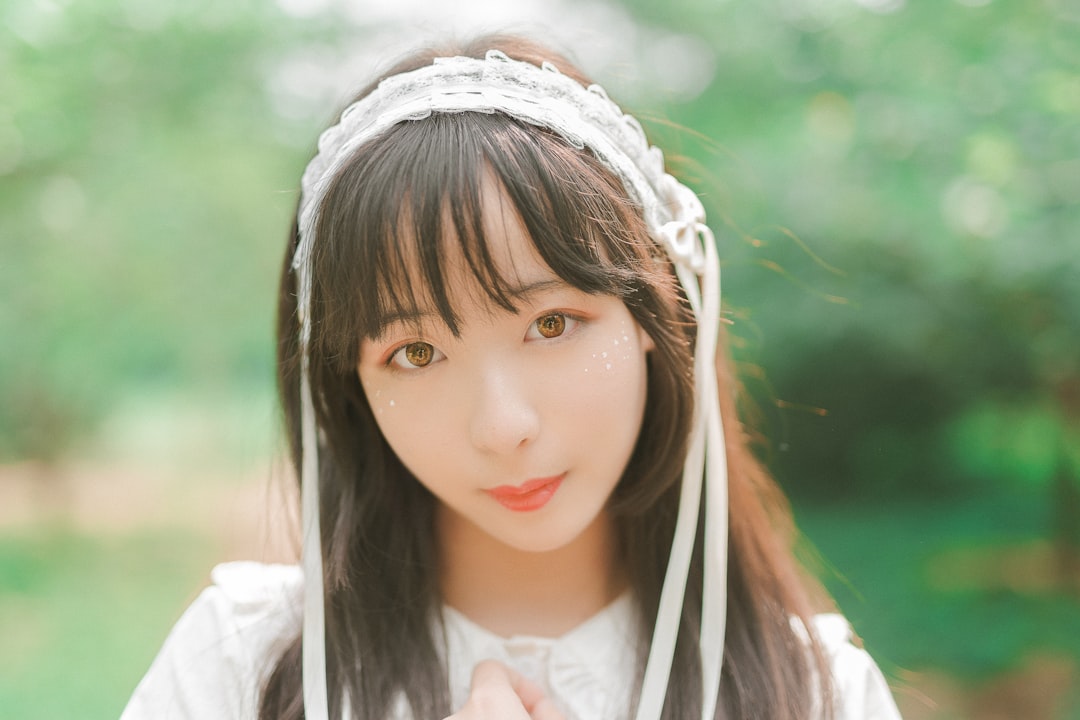 woman wearing white headband and white top