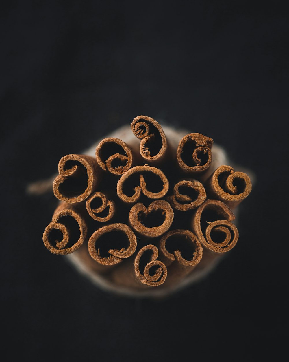 a pile of cinnamon sticks sitting on top of a white plate