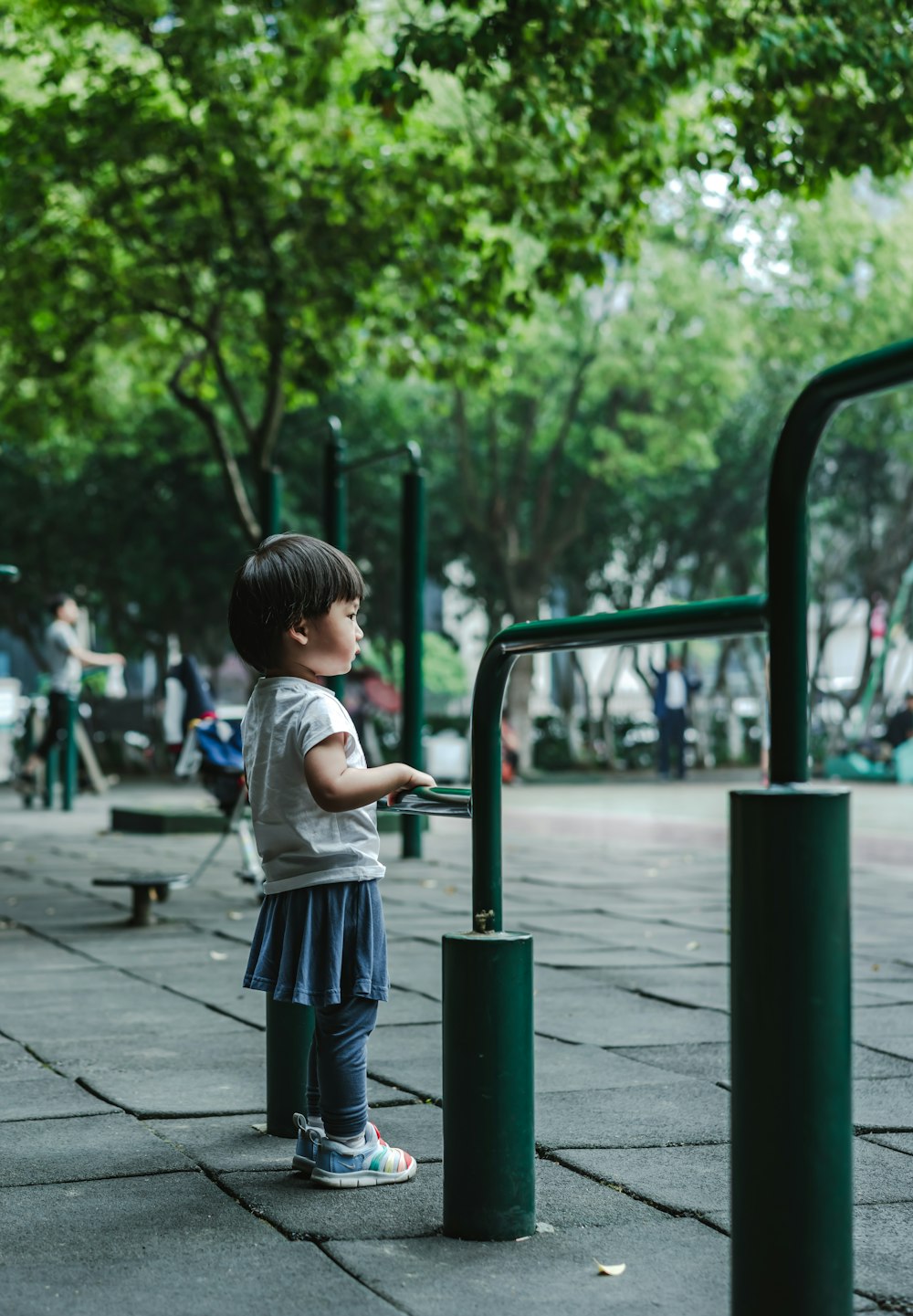 girl standing near green railings