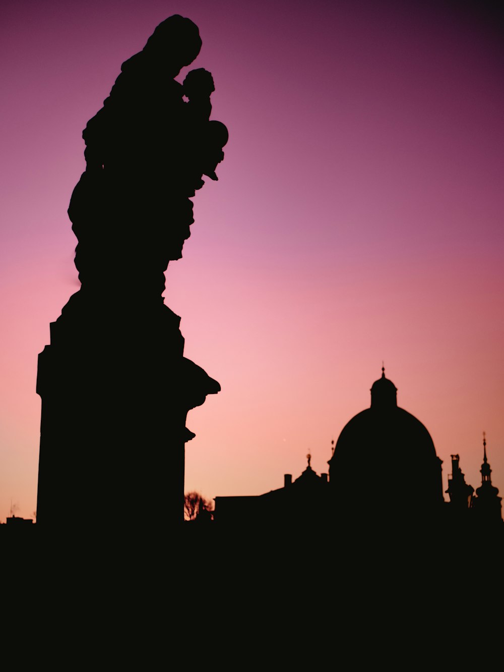 silhouette photography of statue during golden hour