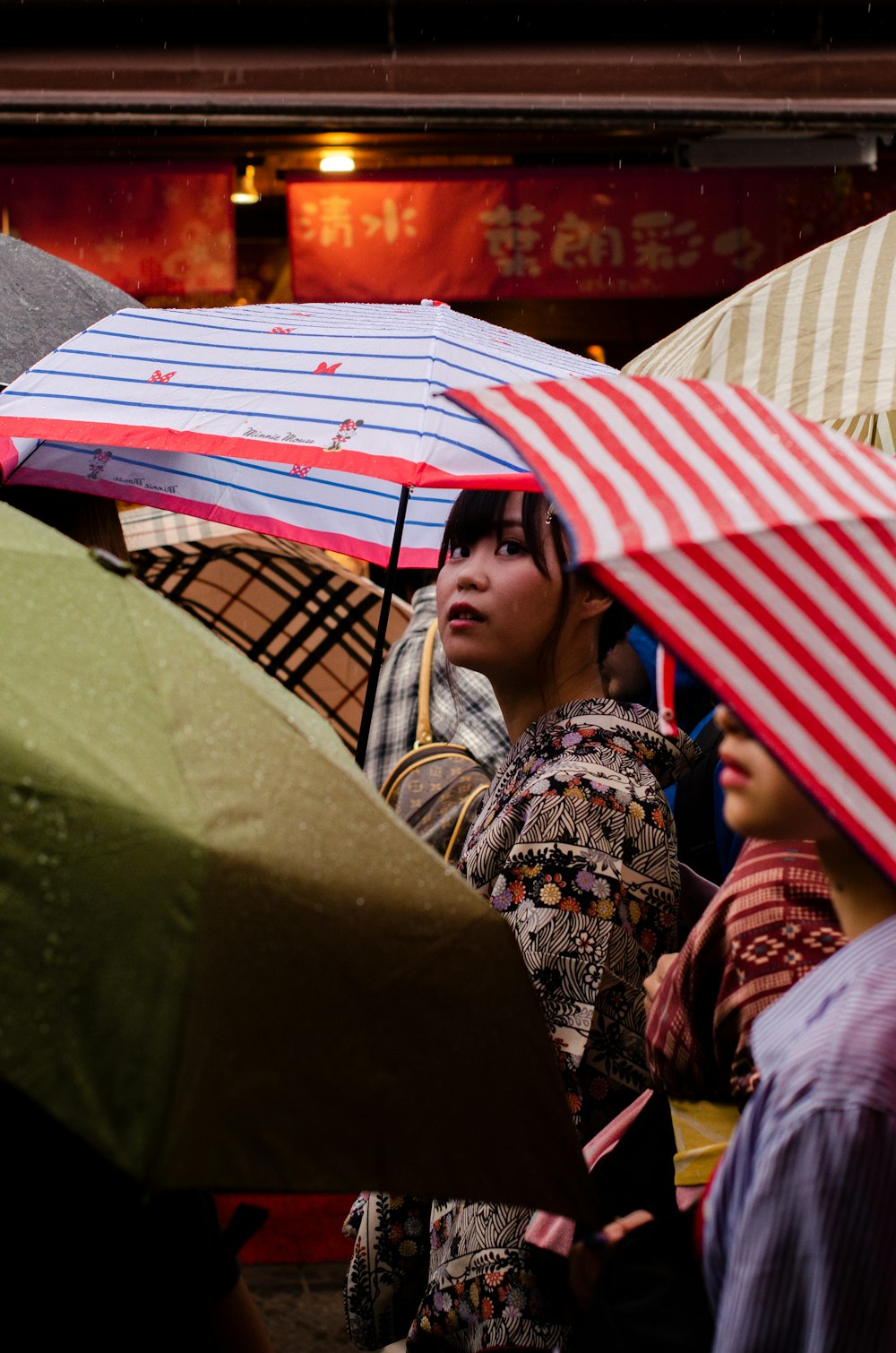 women using a red umbrella during daytime