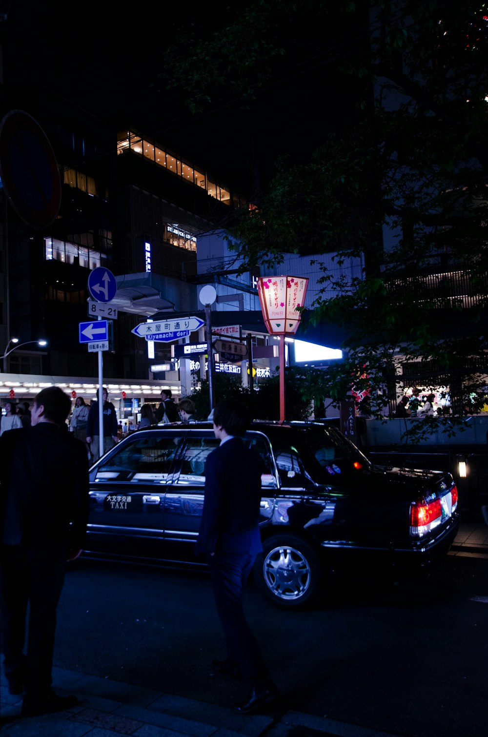 people standing outside near buildings during nighttime