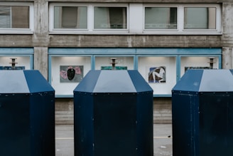 three blue and white portalets on the street