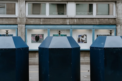 three blue and white portalets on the street