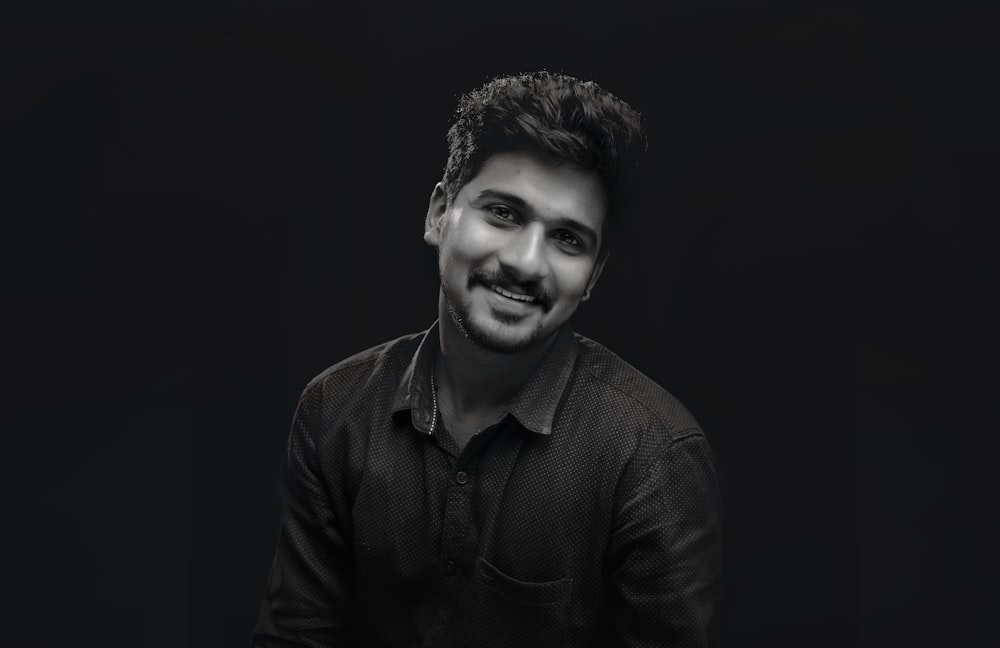 smiling man wearing collared shirt