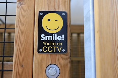 A smiling business owner reviewing security system setup with a Urooj IT Solutions technician.