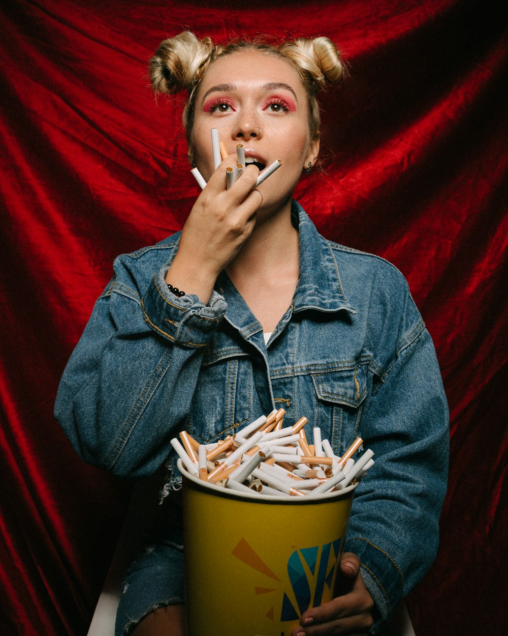 woman carrying bucket of cigarettes