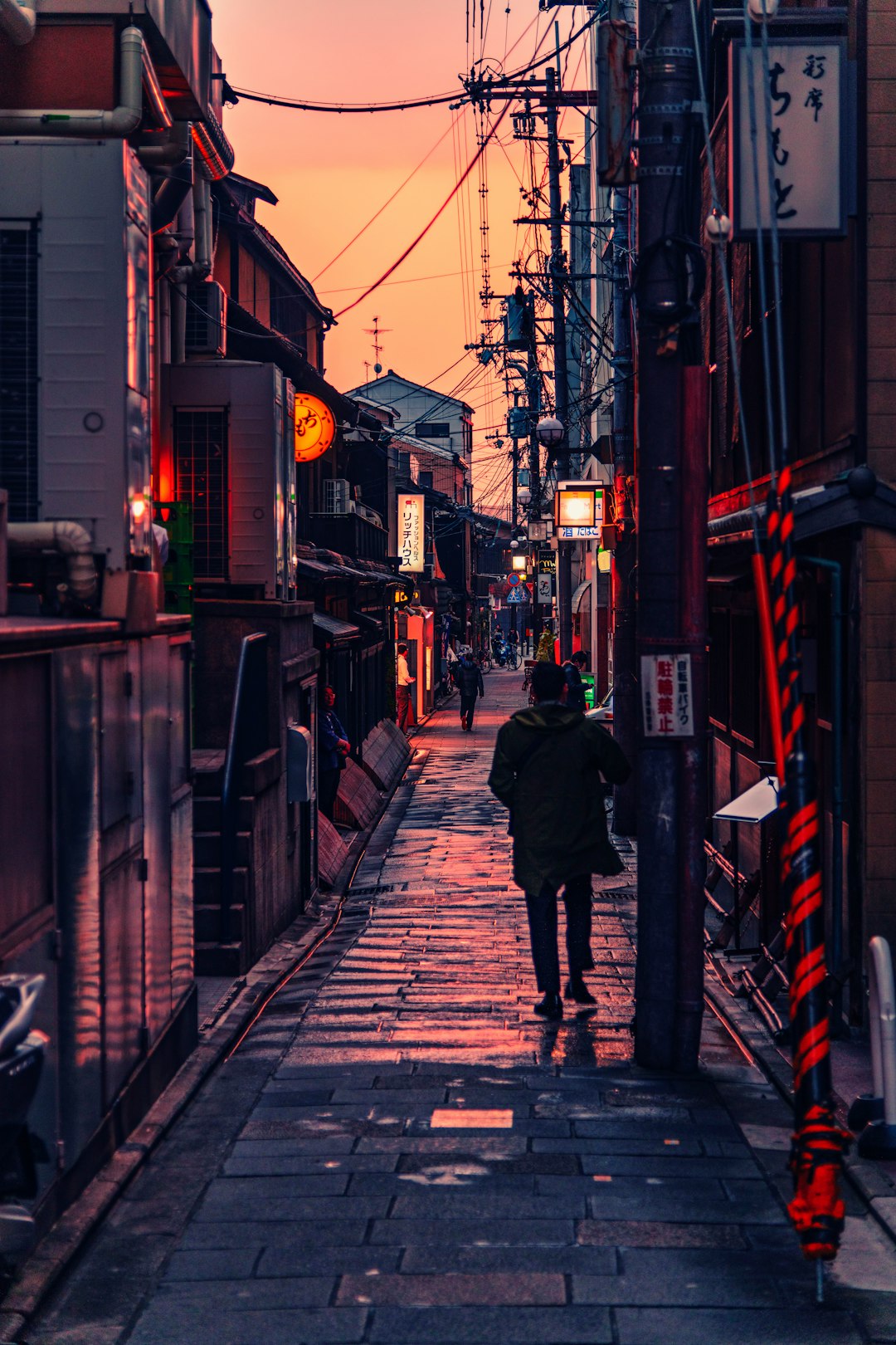 person walking between buildings