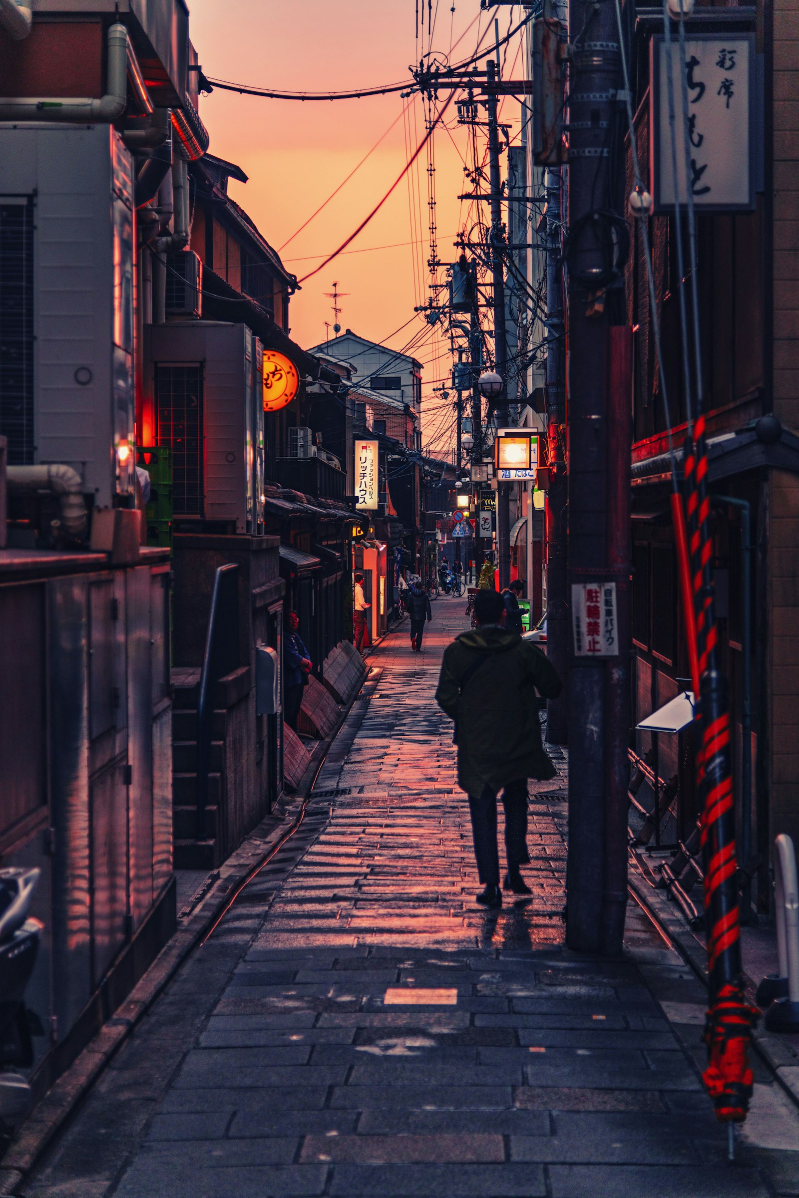 Nikon AF-S Nikkor 24-120mm F4G ED VR sample photo. Person walking between buildings photography