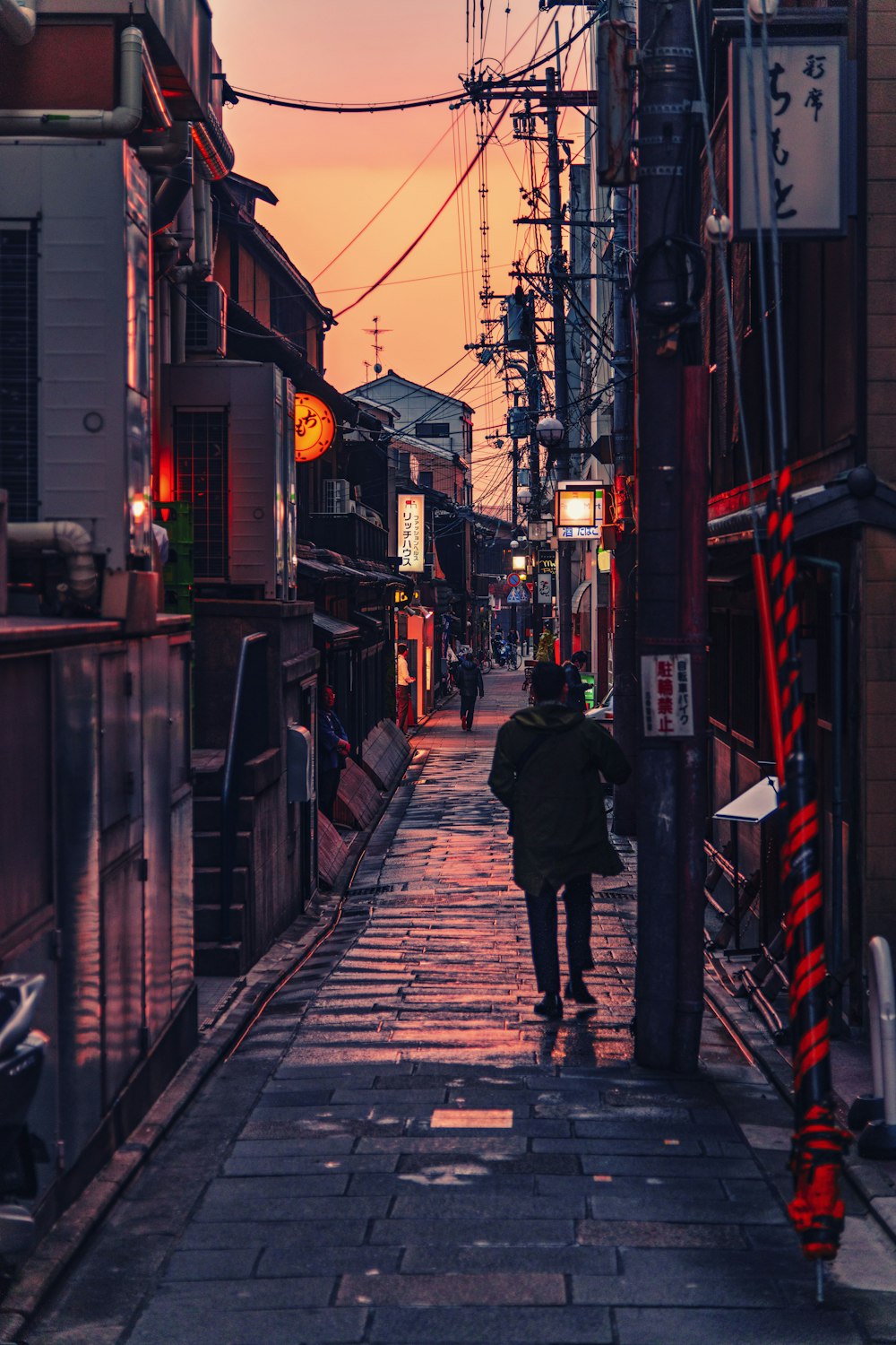 person walking between buildings