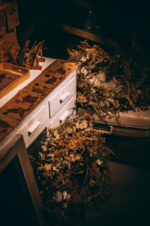 A serene workspace featuring antique tools and dried botanicals used in crafting noiralba scents
