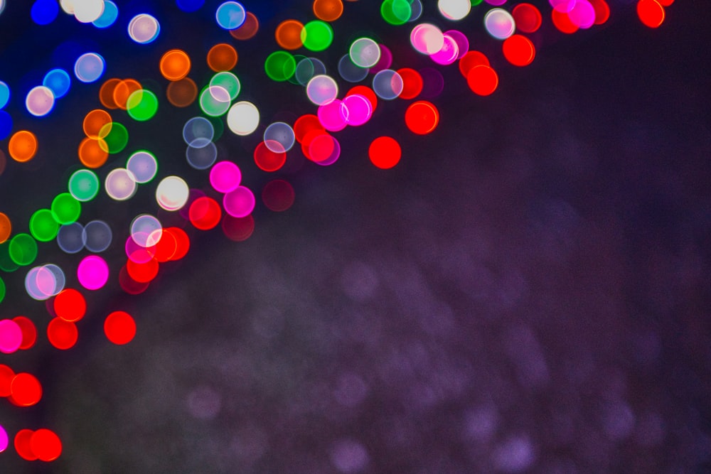 a blurry photo of colorful lights on a dark background