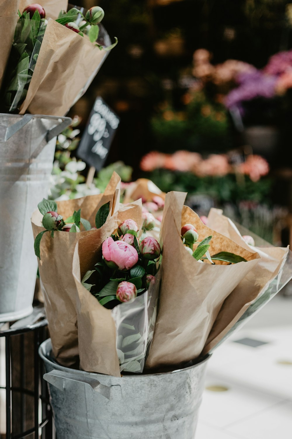 pink flower bouquets on bucket