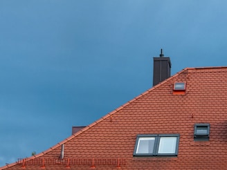 close-up of red roof with skylight under clear sky for drone inspection 