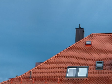 close-up of red roof with skylight under clear sky for drone inspection 
