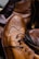 A close-up of fashionable men's footwear displayed on a wooden surface.