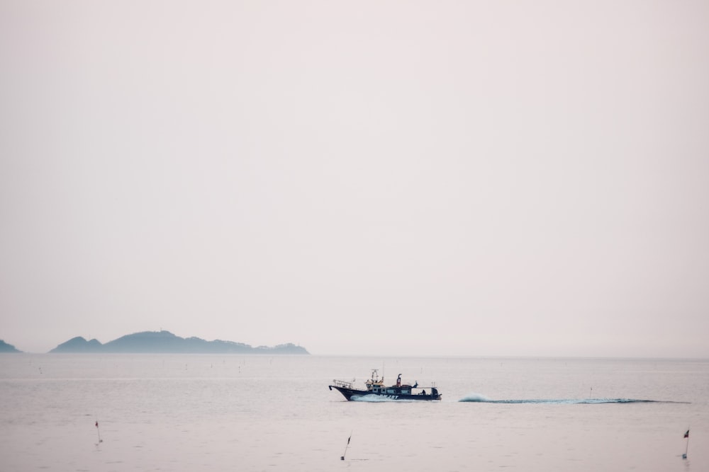 boat floating in the sea during daytime