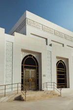 white concrete building with arch doors
