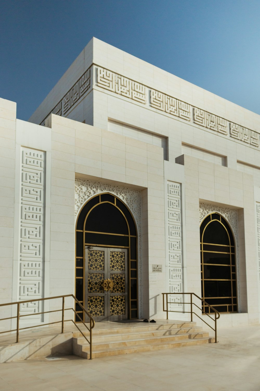 white concrete building with arch doors