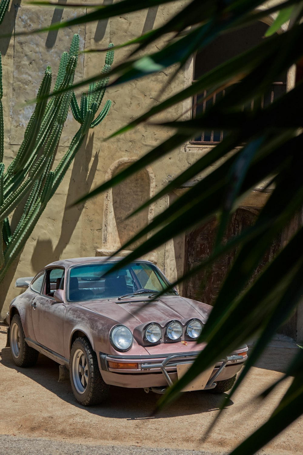 brown vehicle parked near concrete building