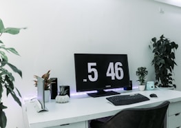 Minimalist workspace featuring a clean white background and digital calendars synced for trading schedules.
