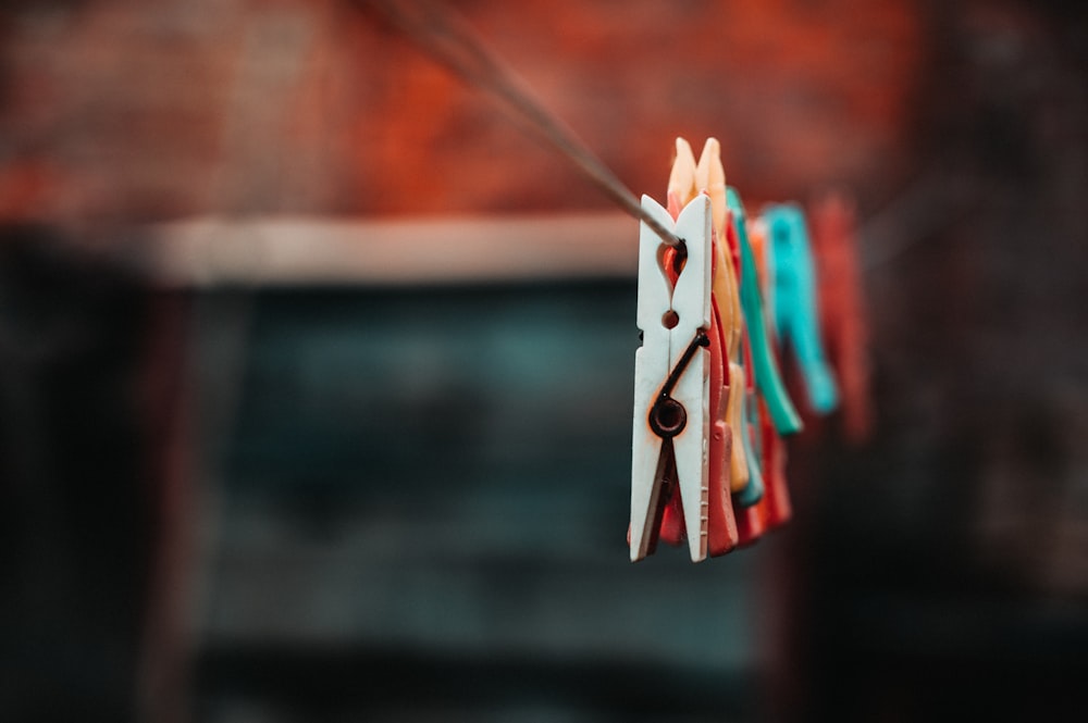 selective focus photography of clothespins on rope
