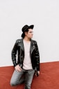 man leaning on white and red wall