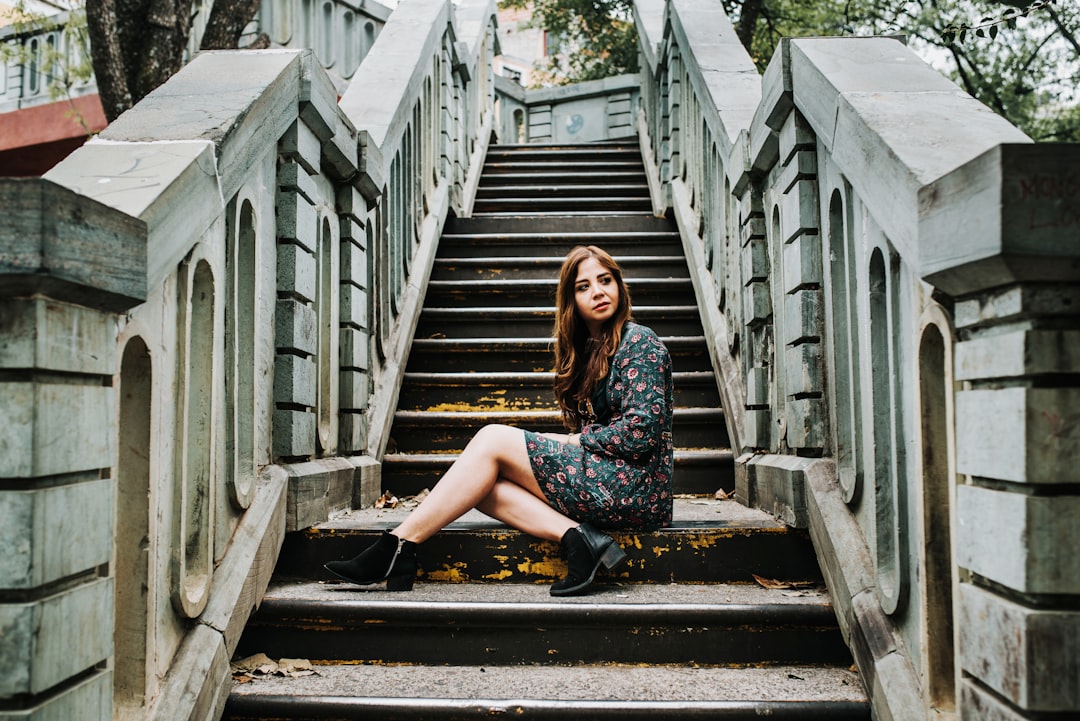 woman sitting on gray concrete stair