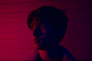 A striking still from a bold documentary featuring vibrant blue and orange lighting.