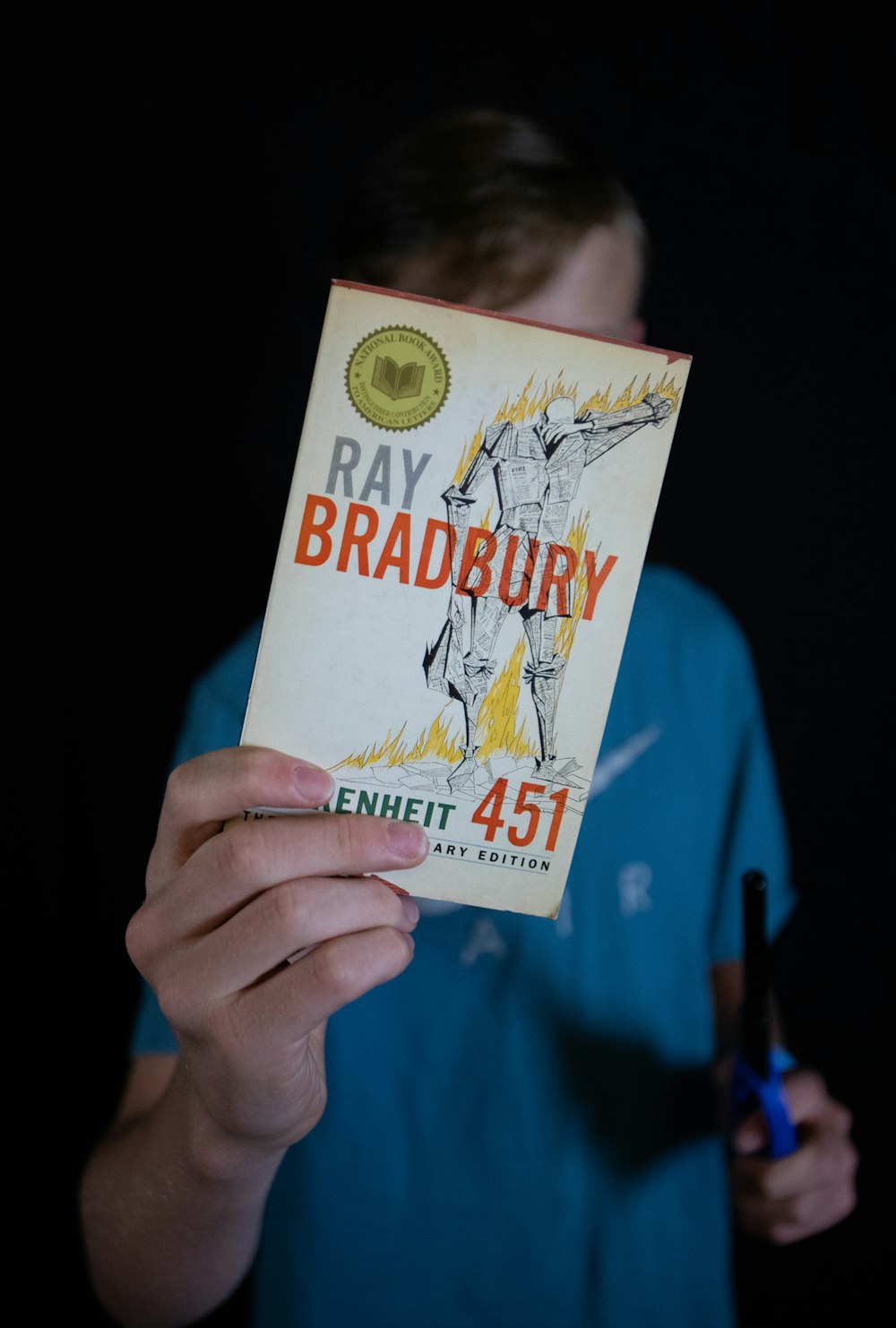 person holding Ray Bradbury book