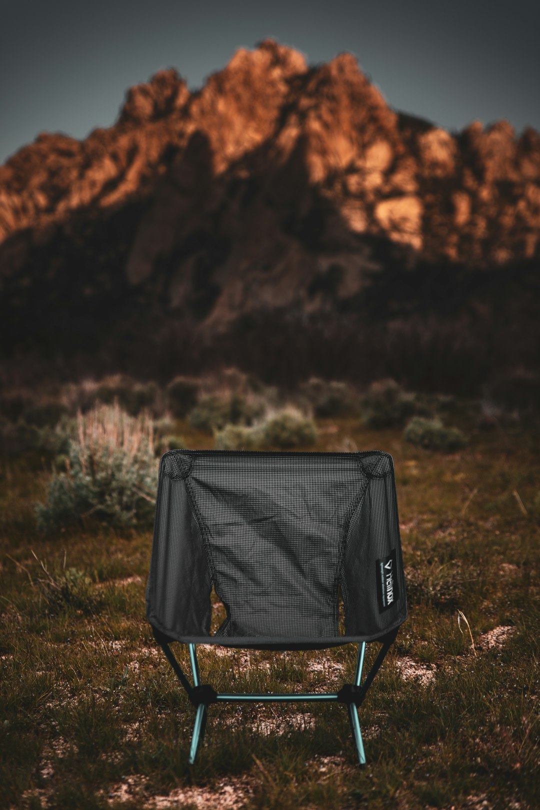 black folding chair facing mountain