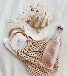 clear glass bottle on white textile