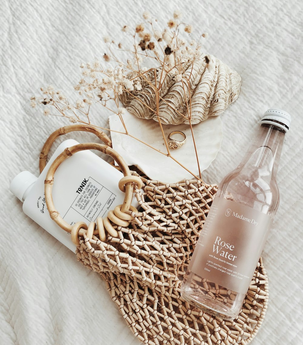 clear glass bottle on white textile