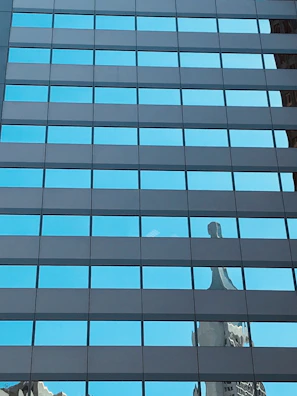 Sparkling clean storefront windows reflecting the street and sky.