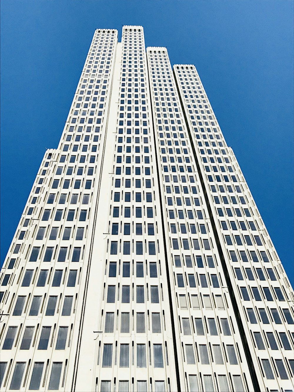 low-angle photography of white high-rise building