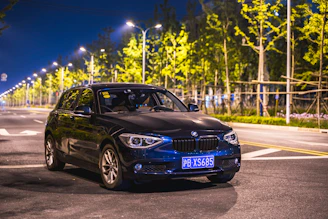 A sleek black limousine parked under city lights, ready for a night out.