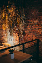 A rustic leather chair set against a backdrop of exposed brick and warm wood tones.