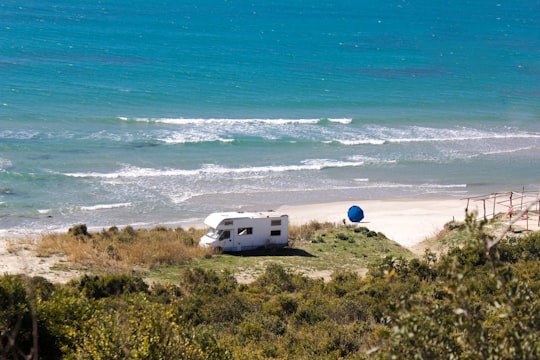 white RV near the ocean in Cape of Rodon Albania